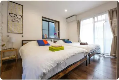 a bedroom with two beds and a large window at Arakawa-ku - House / Vacation STAY 66906 in Tokyo