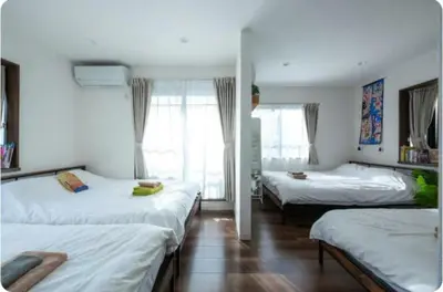 a bedroom with two beds and a window at Arakawa-ku - House / Vacation STAY 66906 in Tokyo