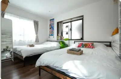 a bedroom with two beds and a window at Arakawa-ku - House / Vacation STAY 66906 in Tokyo