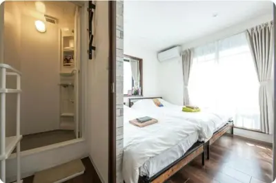 a bedroom with a bed and a large window at Arakawa-ku - House / Vacation STAY 66906 in Tokyo