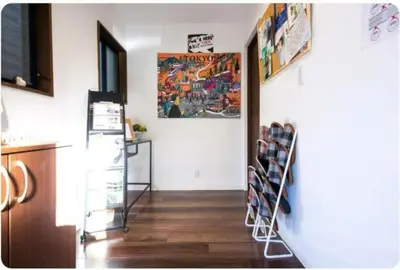 a hallway withographing racks on the wall in a room at Arakawa-ku - House / Vacation STAY 66906 in Tokyo