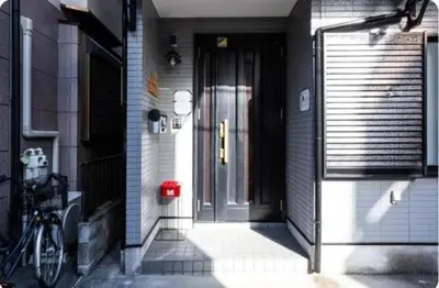 a front door of a house with a bike parked next to it at Arakawa-ku - House / Vacation STAY 66906 in Tokyo