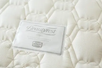 a sign sitting on top of a white mattress at Tosei Hotel Cocone Ueno Okachimachi in Tokyo