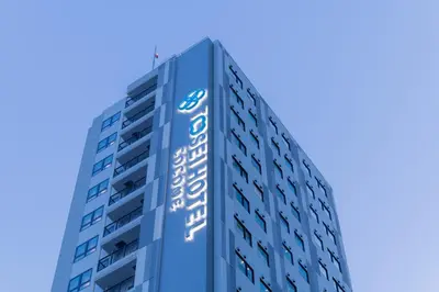a tall blue building with a sign on it at Tosei Hotel Cocone Ueno Okachimachi in Tokyo