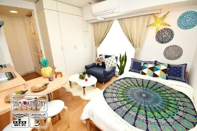 a bedroom with a large bed and a kitchen at KITAZAWA CS HOUSE / Vacation STAY 68573 in Tokyo