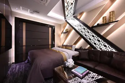 a room with a bed and a couch and a staircase at HOTEL VARKIN ANNEX in Tokyo