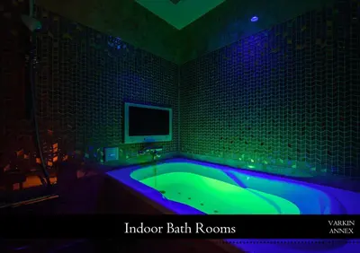 a bathroom with a tub with a tv on the wall at HOTEL VARKIN ANNEX in Tokyo