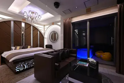 a bedroom with a couch and a bed and a chandelier at HOTEL VARKIN ANNEX in Tokyo