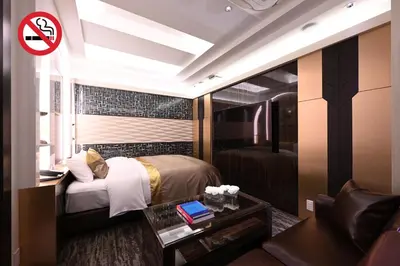 a bedroom with a bed and a room with a couch at HOTEL VARKIN ANNEX in Tokyo