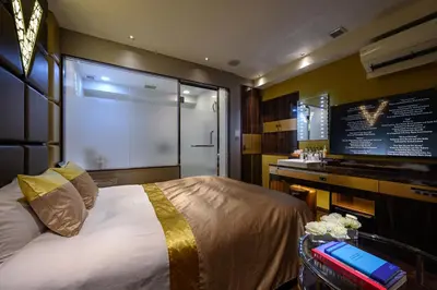 a bedroom with a large bed and a large screen at HOTEL VARKIN ANNEX in Tokyo