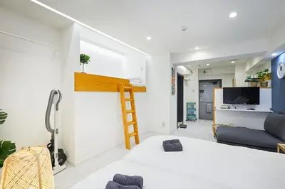 a bedroom with a bed and a ladder on the wall at STAY ARI Kabukicho in Tokyo