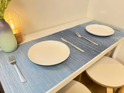 two white plates and utensils on a table at nestay inn tokyo kagurazaka in Tokyo