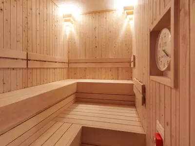 a small sauna with a clock on the wall at Smart Stay SHIZUKU Ueno Ekimae in Tokyo