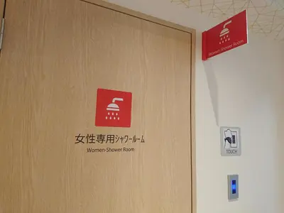 a door in a building with a sign on it at Smart Stay SHIZUKU Ueno Ekimae in Tokyo