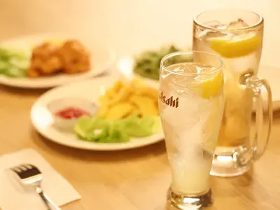 a drink in a glass on a table with a plate of food at Smart Stay SHIZUKU Ueno Ekimae in Tokyo