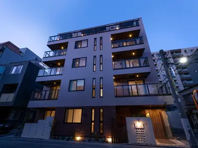 a tall apartment building at night with lights on at Hotel SAILS Asakusa in Tokyo