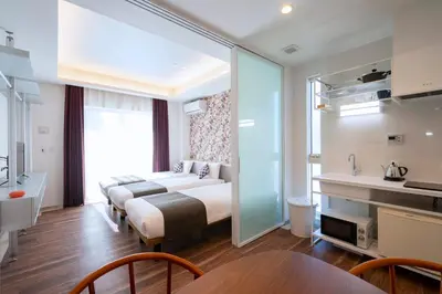 a hotel room with two beds and a table at Hotel SAILS Asakusa in Tokyo