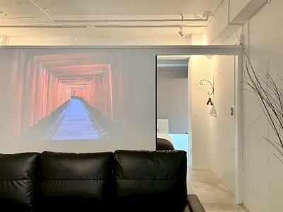 a couch in a room with a painting on the wall at GalleryInn Fuji, Shibuya in Tokyo
