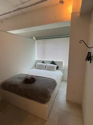 a bedroom with a bed with two towels on it at GalleryInn Fuji, Shibuya in Tokyo