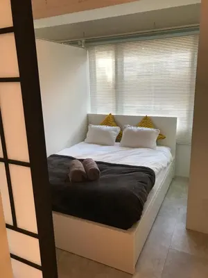 a bedroom with a large bed with two pillows at GalleryInn Fuji, Shibuya in Tokyo