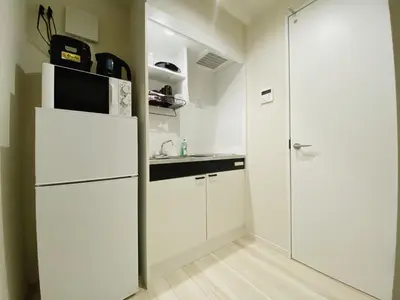 a white kitchen with a refrigerator and a sink at Shibuya Stay Tokyo B103 in Tokyo