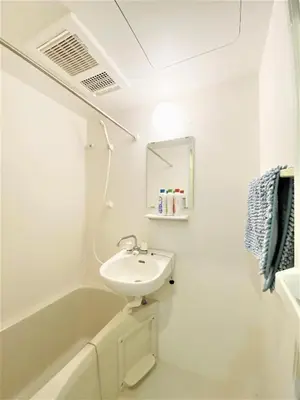 a white bathroom with a sink and a bath tub at Shibuya Stay Tokyo B103 in Tokyo