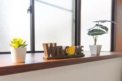 a window sill with a wooden sign that says wife at nestay suite tokyo tabata in Tokyo