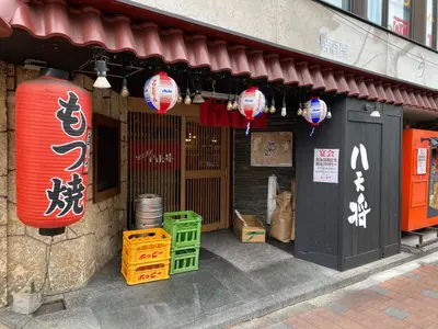 a store with red and white lanterns in front of a building at nestay suite tokyo tabata 03 in Tokyo
