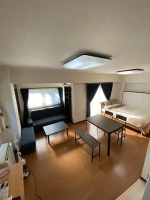 a living room with a bed and a table at G&R House 101 in Tokyo