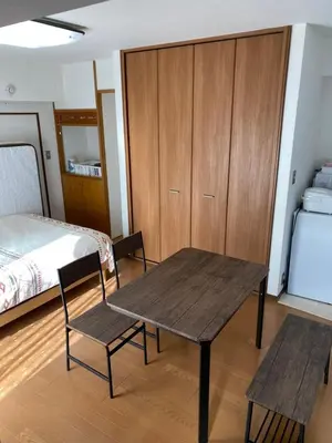 a room with a table and a bed and a table and chairs at G&R House 101 in Tokyo