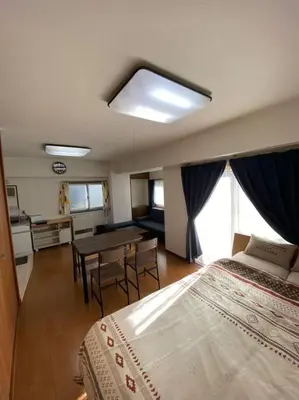 a bedroom with a bed and a table in it at G&R House 101 in Tokyo