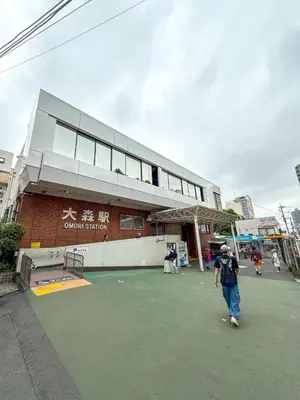 a man walking in front of a building at Eims stay Oomori206 in Tokyo