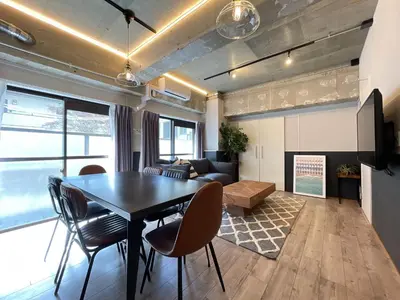 a living room with a table and chairs and a couch at Eims stay Oomori206 in Tokyo