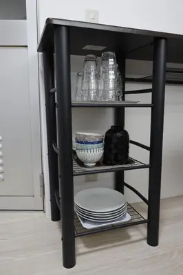a black shelf with plates and dishes on it at G&R House 201 in Tokyo