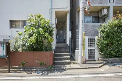 a house with a blue door and stairs in front at G&R House 201 in Tokyo