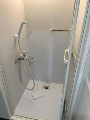a shower in a bathroom with a hose on the wall at G&R House 201 in Tokyo