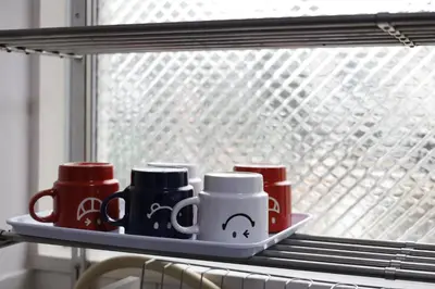a tray with coffee cups on a window sill at G&R House 201 in Tokyo