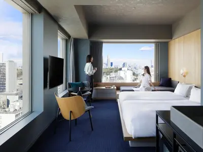 a hotel room with a large bed and a large window at sequence MIYASHITA PARK - Shibuya in Tokyo