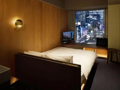 a hotel room with a bed and a window at sequence MIYASHITA PARK - Shibuya in Tokyo