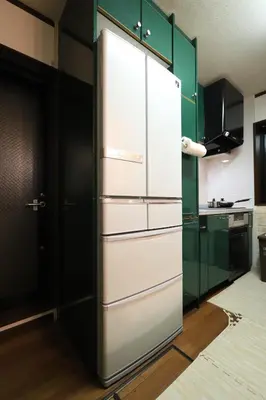 a white refrigerator in a kitchen with green cabinets at RKT4bedroom ForFamily 30mins Shibuya and Azabu in Tokyo