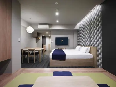a hotel room with a bed and a dining room at MONday Apart Ueno Shinokachimachi in Tokyo