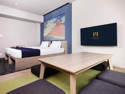 a hotel room with a bed and a table at MONday Apart Ueno Shinokachimachi in Tokyo