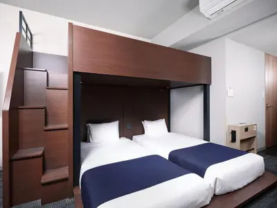a bedroom with a large bed with a wooden headboard at MONday Apart Ueno Shinokachimachi in Tokyo