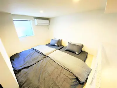 a bedroom with a bed in the corner of a room at Shibuya-ku - Apartment / Vacation STAY 6219 in Tokyo