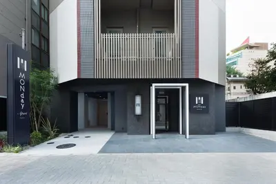 a building with a door in the middle of it at MONday Apart Hamamatsucho Daimon in Tokyo