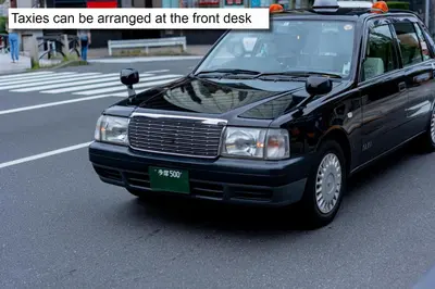 a black car is parked on a city street at MONday Apart Hamamatsucho Daimon in Tokyo