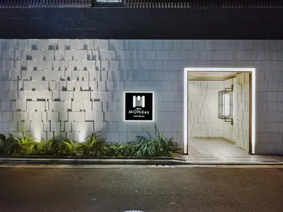 a door to a building with a sign on it at MONday Apart Premium Nihonbashi in Tokyo