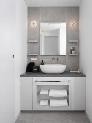 a bathroom with a sink and a mirror and towels at BnA WALL in Tokyo