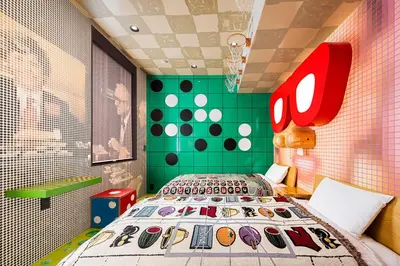 a bedroom with a bed and a green wall at BnA WALL in Tokyo