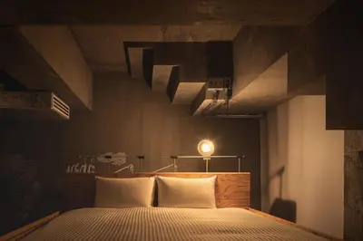 a bedroom with a bed with white pillows at BnA WALL in Tokyo
